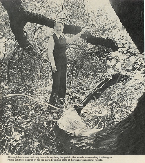 Photograph of Phyllis A. Whitney in the woods surrounding her New Jersey home. Photograph by Maje Waldo.