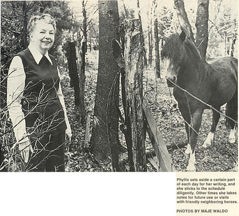 Photograph of Phyllis A. Whitney visiting with a neighbor's horse. Photograph by Maje Waldo.